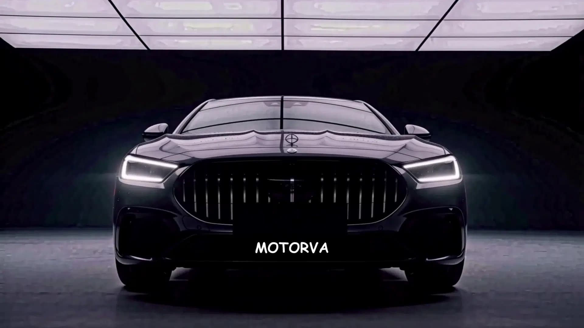 Front three-quarter view of luxury vehicle illuminated under dark studio reveal array with MOTORVA insignia